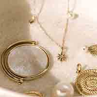 Jewelry including Golden necklace with start pendant